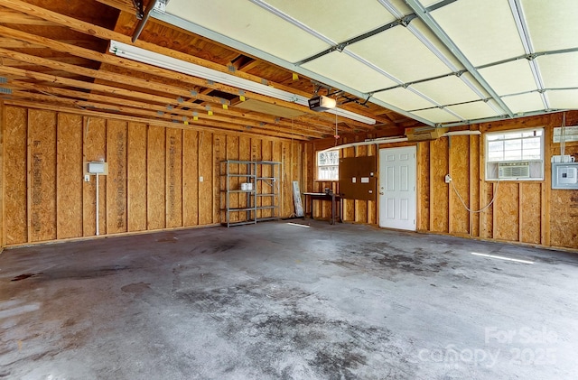 garage featuring cooling unit and a garage door opener
