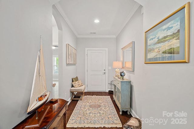 corridor with dark wood-type flooring and ornamental molding