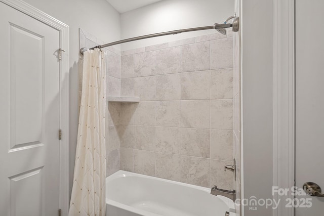 bathroom featuring shower / bath combo with shower curtain