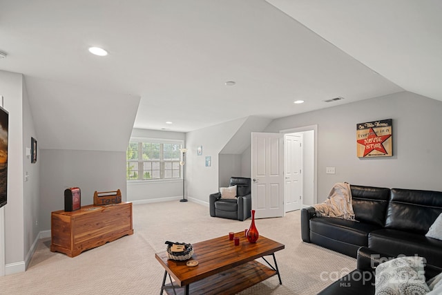 carpeted living room with lofted ceiling