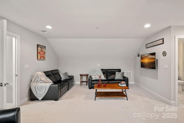 carpeted living room with vaulted ceiling