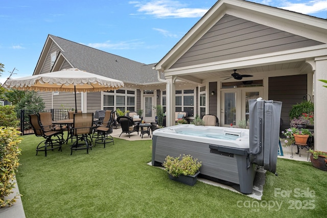 rear view of property with a yard, a patio area, a hot tub, and ceiling fan