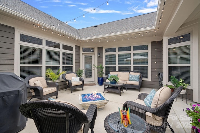 view of patio / terrace with grilling area and an outdoor living space with a fire pit