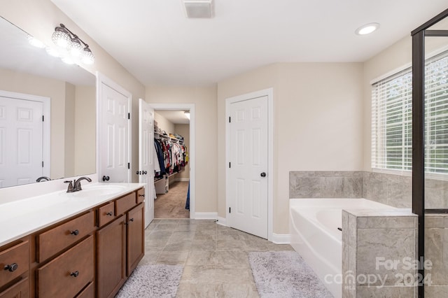 bathroom with vanity and a bathtub