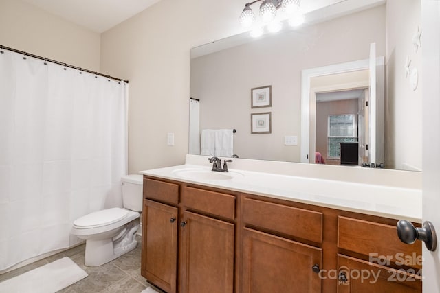 bathroom featuring tile patterned floors, vanity, and toilet