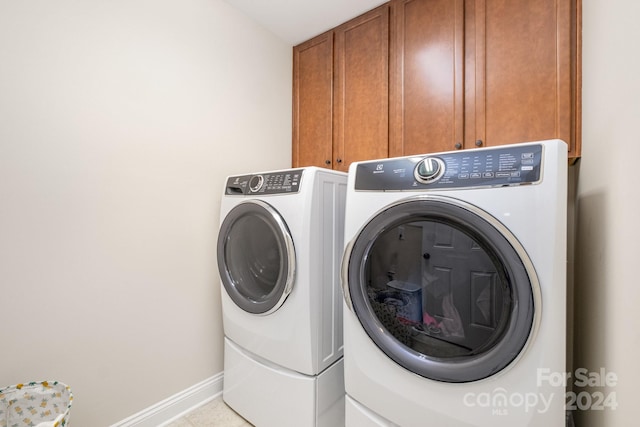 laundry area featuring independent washer and dryer and cabinets