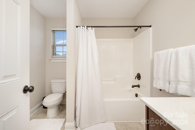 full bathroom with shower / tub combo with curtain, tile patterned floors, vanity, and toilet