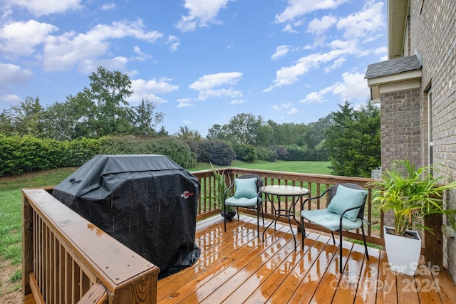 wooden terrace featuring a grill