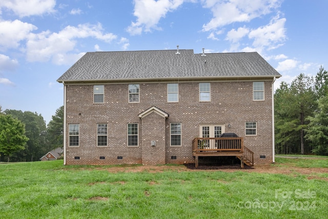 back of house featuring a deck and a yard