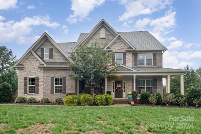 craftsman inspired home featuring a front yard and a porch