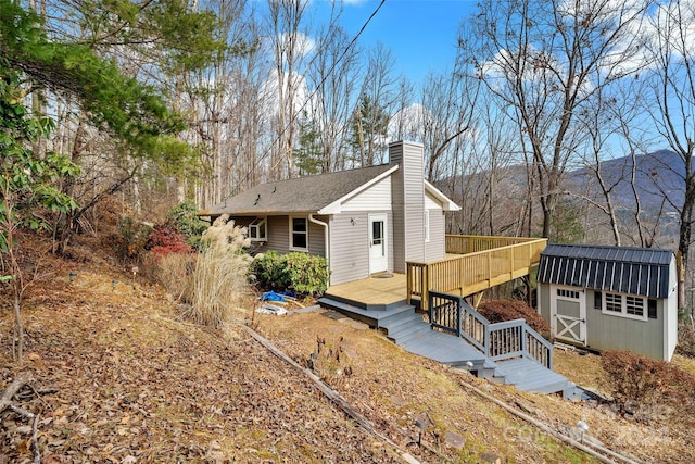 exterior space with a deck with mountain view and a shed