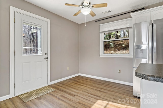 interior space with light wood-type flooring and ceiling fan