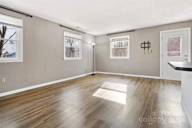 spare room with hardwood / wood-style floors and a textured ceiling