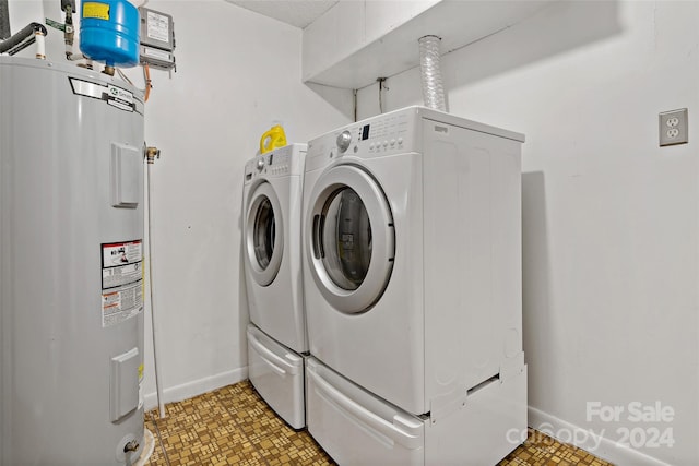 laundry area featuring electric water heater and washer and clothes dryer