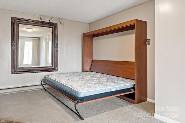 bedroom with a textured ceiling, carpet floors, and baseboard heating