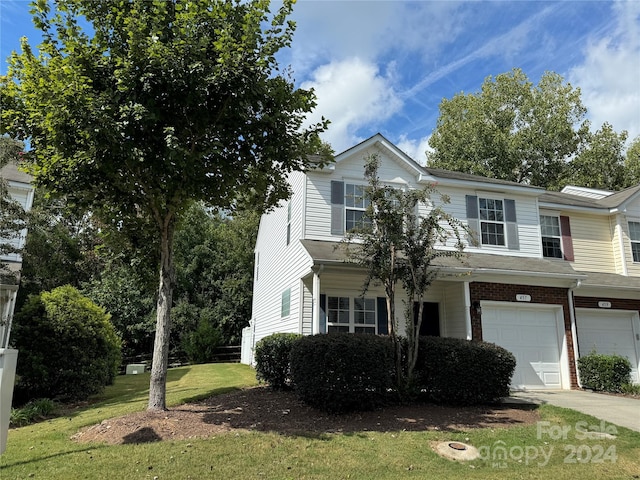 view of front of house with a garage and a front lawn