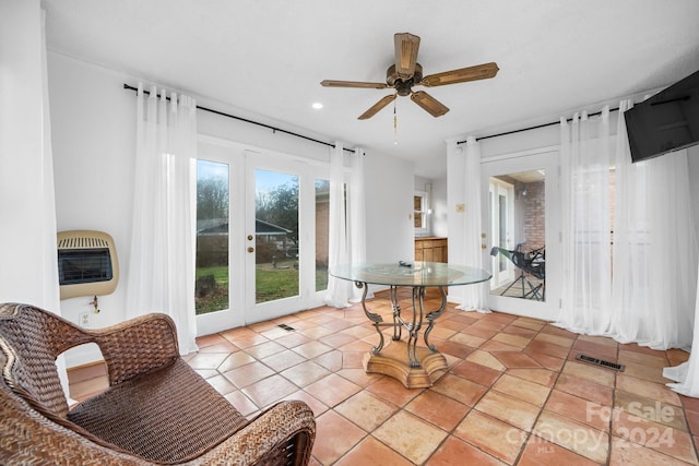 interior space featuring ceiling fan, french doors, and heating unit