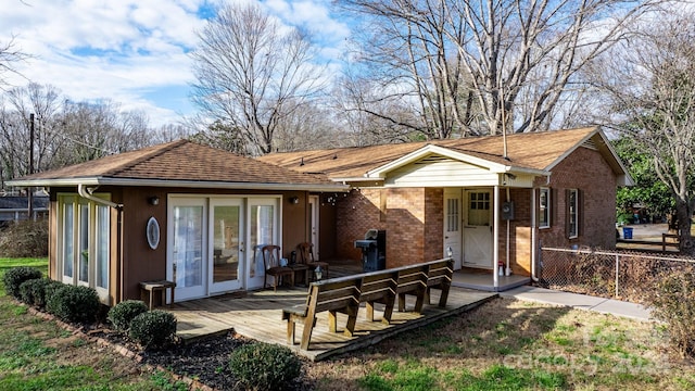 rear view of house featuring a deck