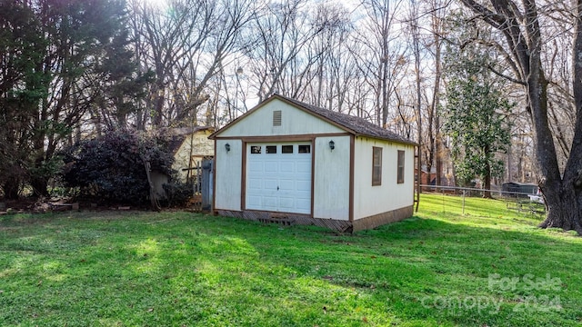 view of outdoor structure with a garage and a yard