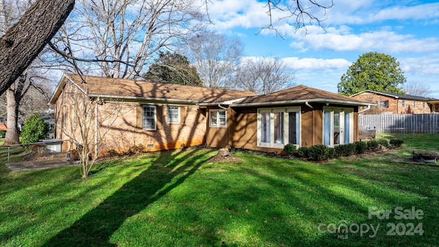 rear view of house with a lawn