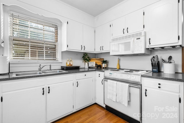 kitchen with white cabinetry, white appliances, sink, and light hardwood / wood-style flooring