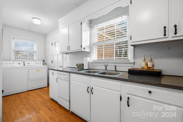 kitchen featuring dishwasher, washer and clothes dryer, a healthy amount of sunlight, and sink