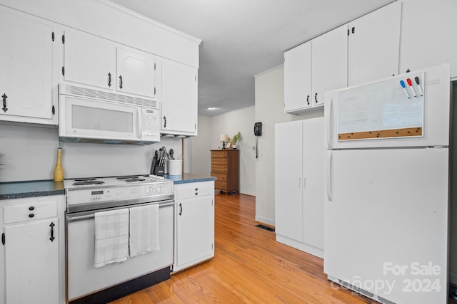 kitchen featuring white appliances, light hardwood / wood-style floors, and white cabinetry