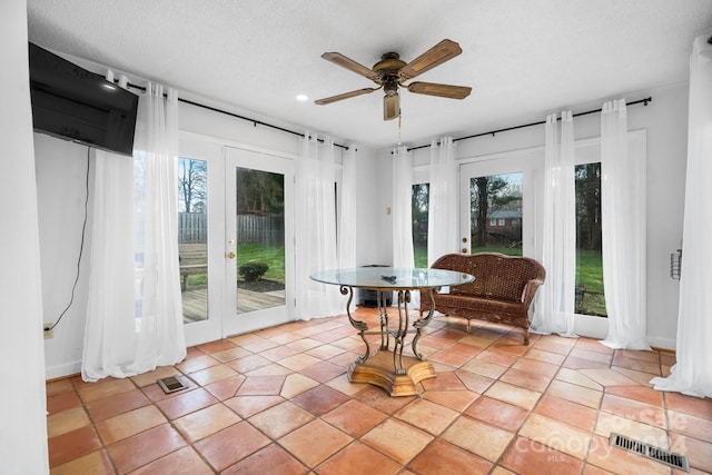 interior space with ceiling fan