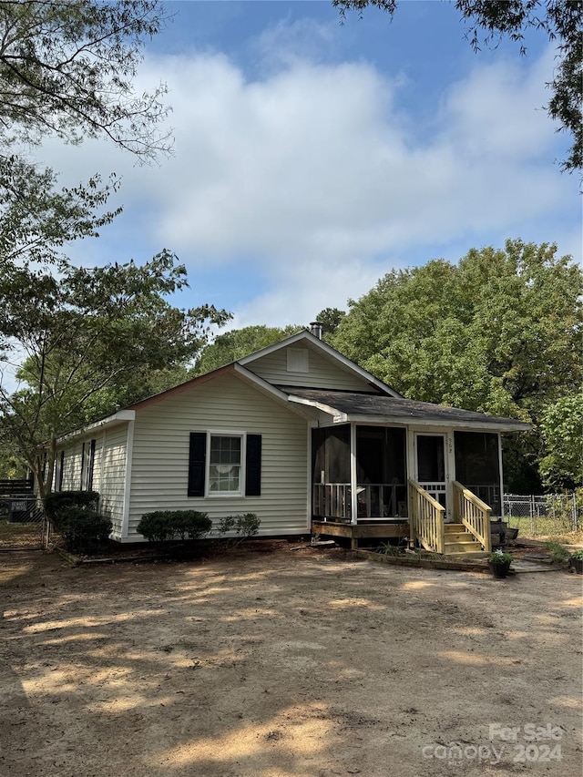 view of front of home featuring a sunroom