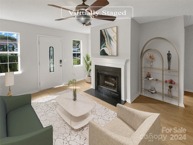 living room featuring light wood-type flooring and ceiling fan