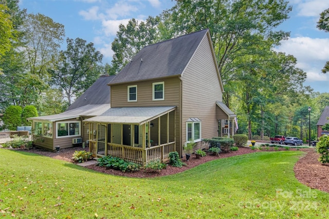 rear view of property with a lawn and a porch