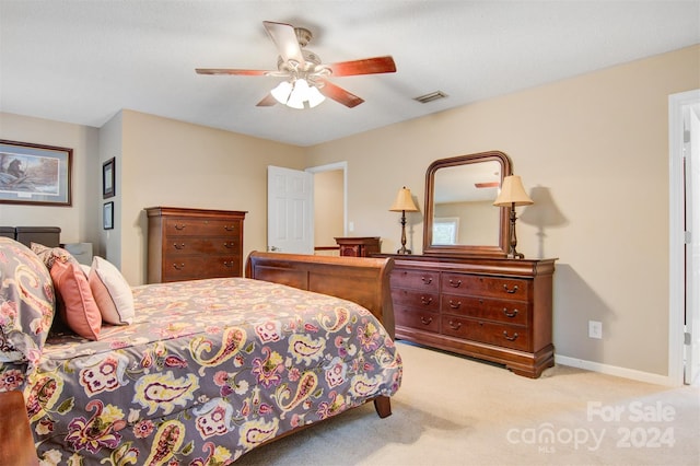 bedroom featuring light carpet and ceiling fan