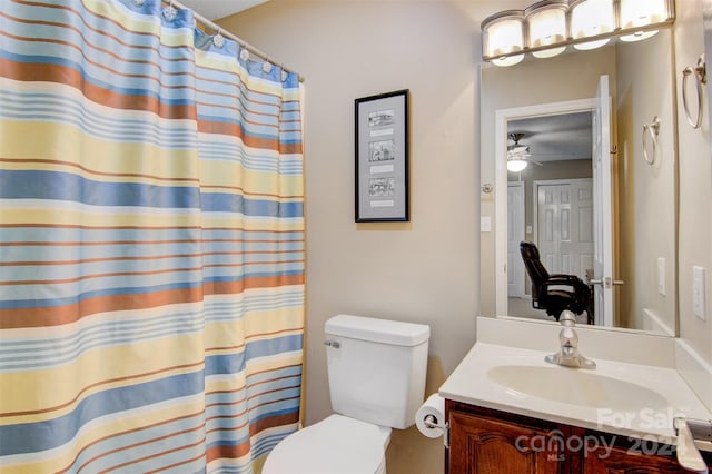 bathroom featuring vanity, toilet, ceiling fan, and a shower with curtain