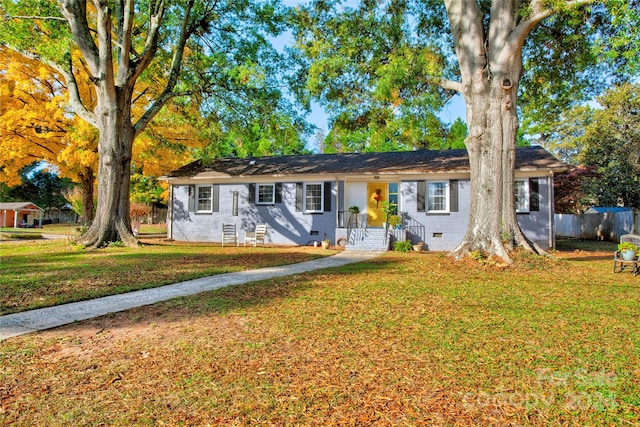 ranch-style home featuring a front yard