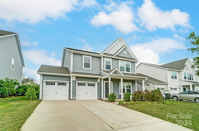 view of front of home featuring a front lawn, a porch, and a garage