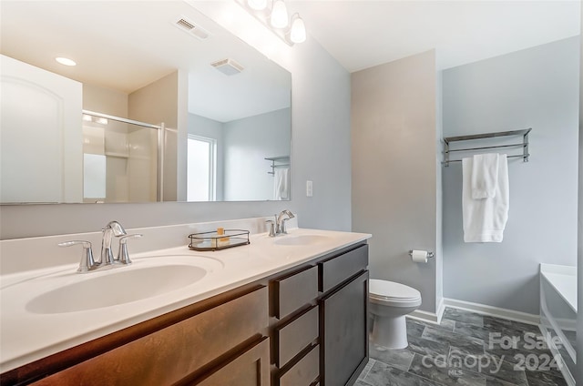 full bathroom featuring toilet, vanity, and separate shower and tub