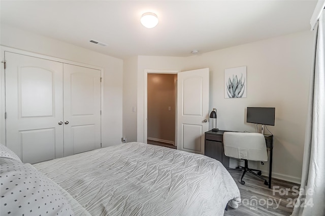 bedroom with hardwood / wood-style flooring and a closet