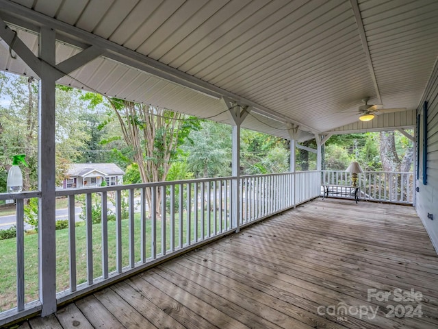 deck featuring ceiling fan and a lawn