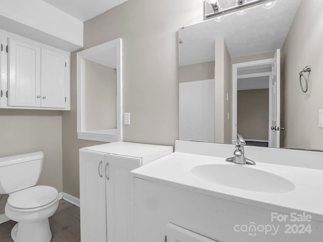 bathroom featuring vanity, toilet, and tile patterned floors