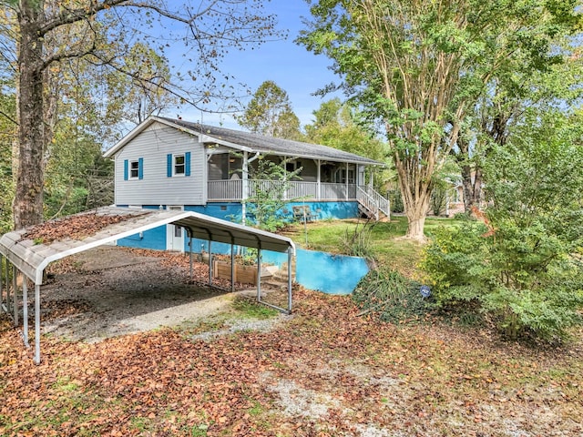 back of property with a sunroom