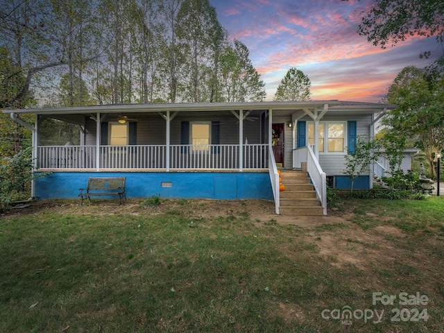 view of front of property with a yard and a porch