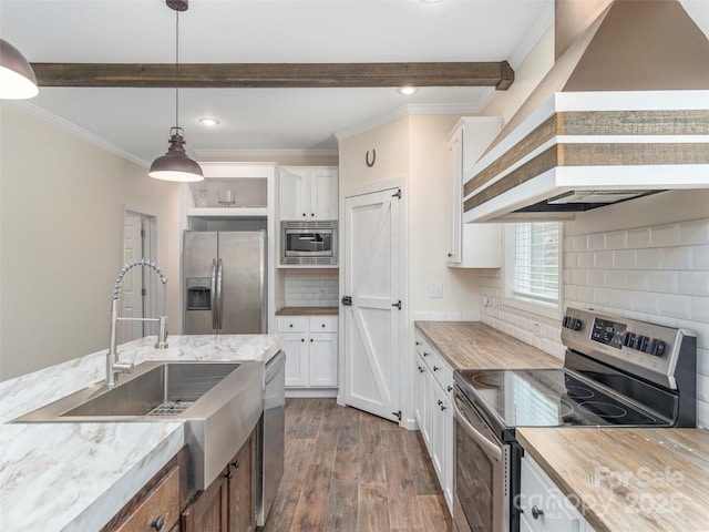 kitchen featuring dark wood-type flooring, white cabinetry, hanging light fixtures, stainless steel appliances, and custom exhaust hood