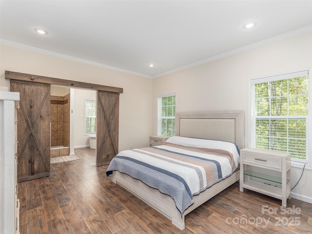 bedroom with dark wood-type flooring, a barn door, and multiple windows