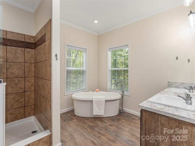 bathroom with crown molding, plenty of natural light, and hardwood / wood-style floors