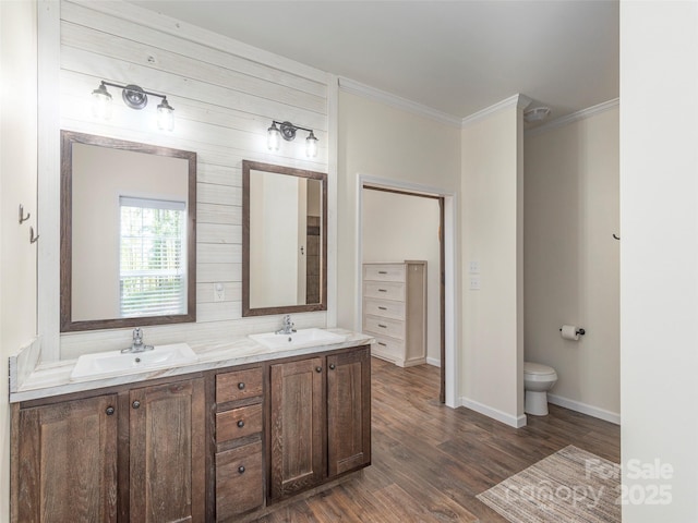 bathroom featuring hardwood / wood-style flooring, vanity, and crown molding