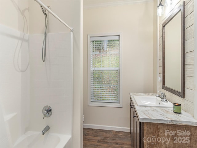 bathroom featuring hardwood / wood-style flooring, bathing tub / shower combination, vanity, and crown molding