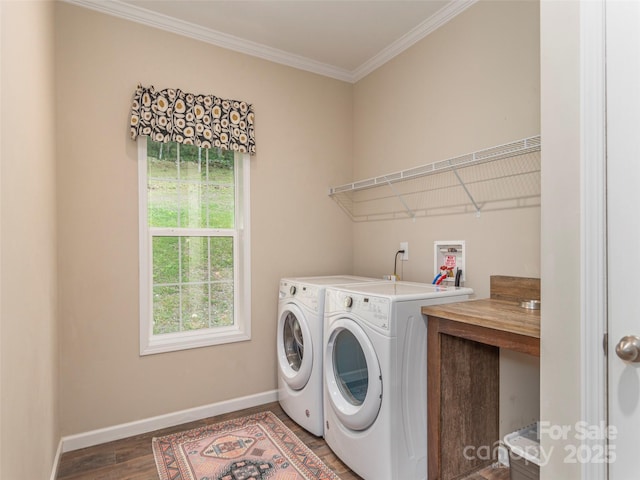 washroom featuring ornamental molding, dark hardwood / wood-style flooring, and separate washer and dryer