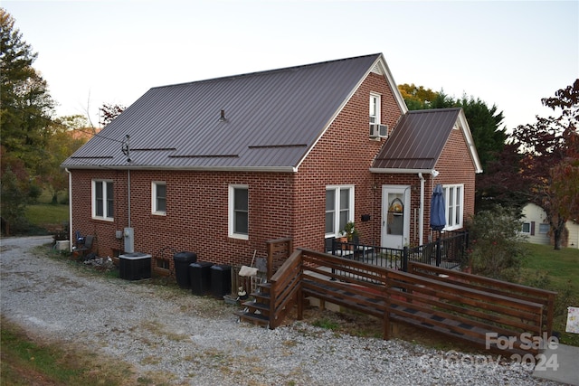 exterior space featuring a wooden deck and cooling unit