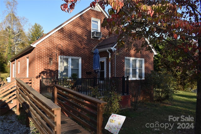 view of front facade with a deck and cooling unit