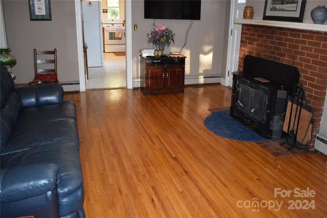 living room with baseboard heating and wood-type flooring